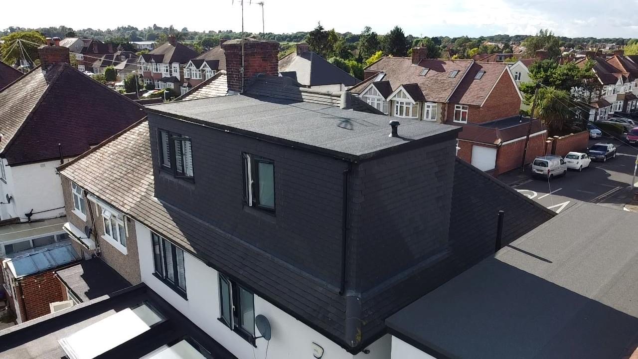 The finished dormer from the corner of the plot on a clear day