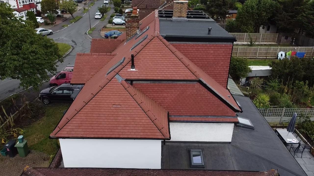 Completed re-roof in red clay tiles, seen from above the street