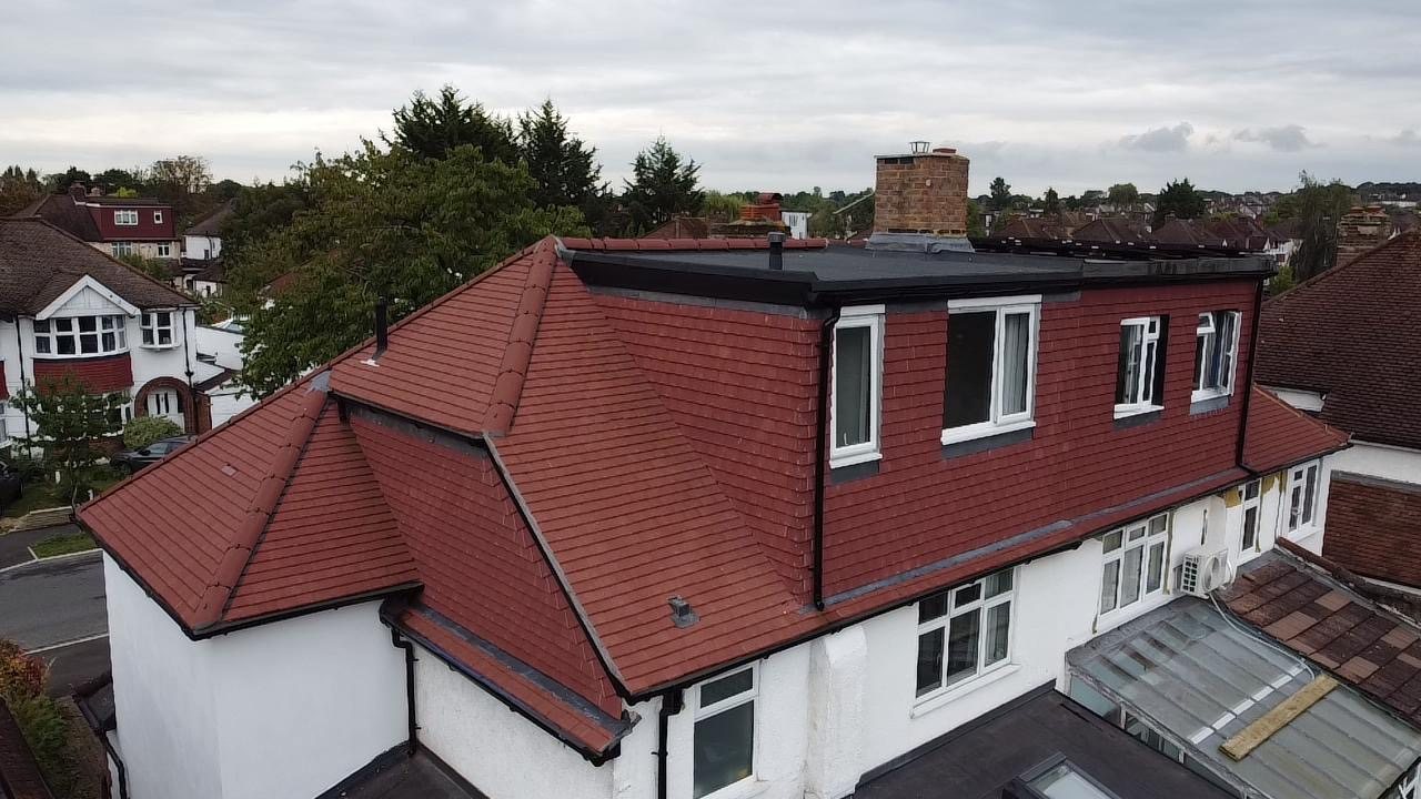 The tile-hung rear dormer above the newly tiled roof