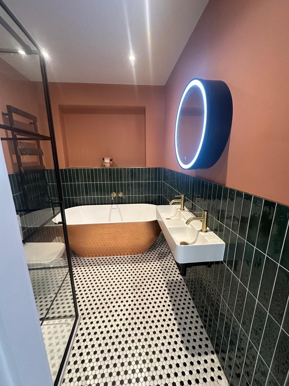 Bathroom with copper bath, green tiles and penny mosaic floor, Wimbledon