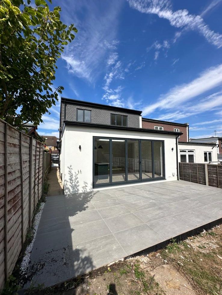 Rear of a fully refurbished bungalow with loft dormer and new patio, Chessington