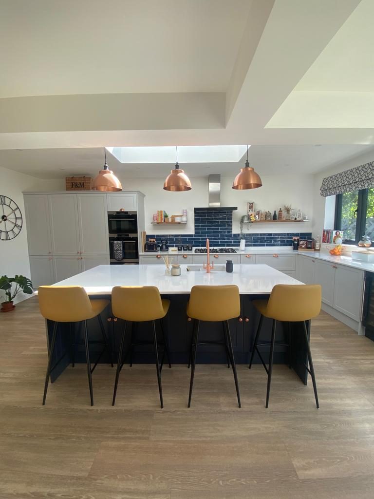 Navy island kitchen with copper pendants, Chessington