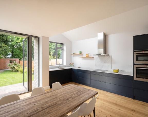 Navy kitchen opening to the garden, Surbiton