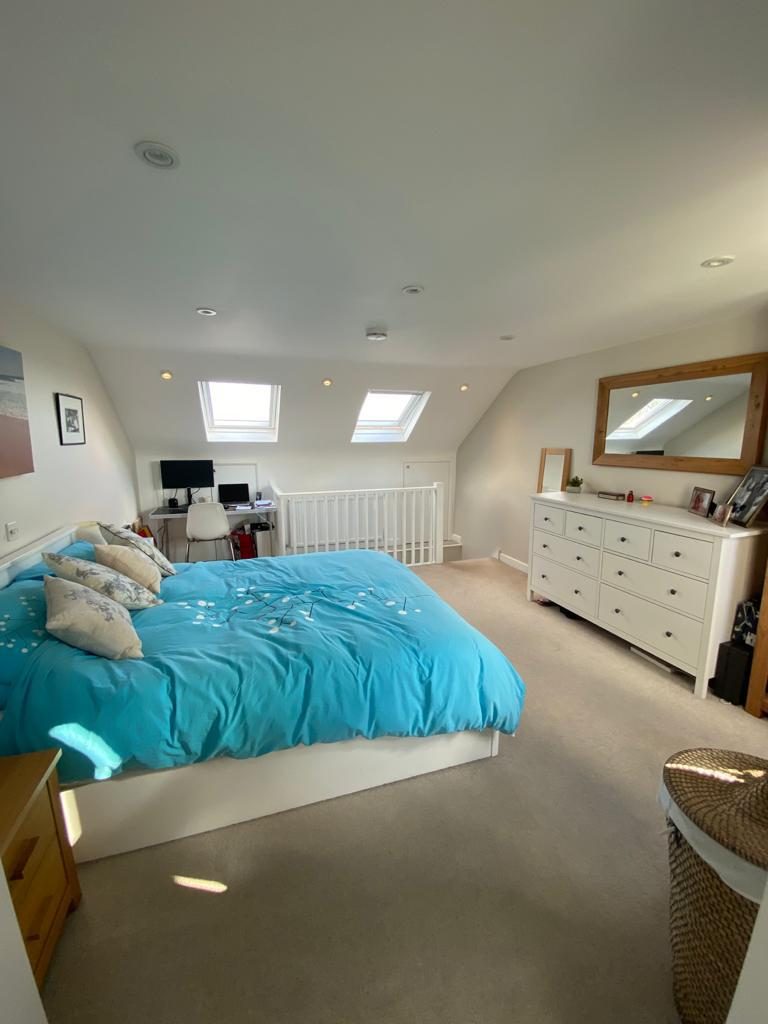 Sunlit loft master bedroom with Velux windows, Worcester Park