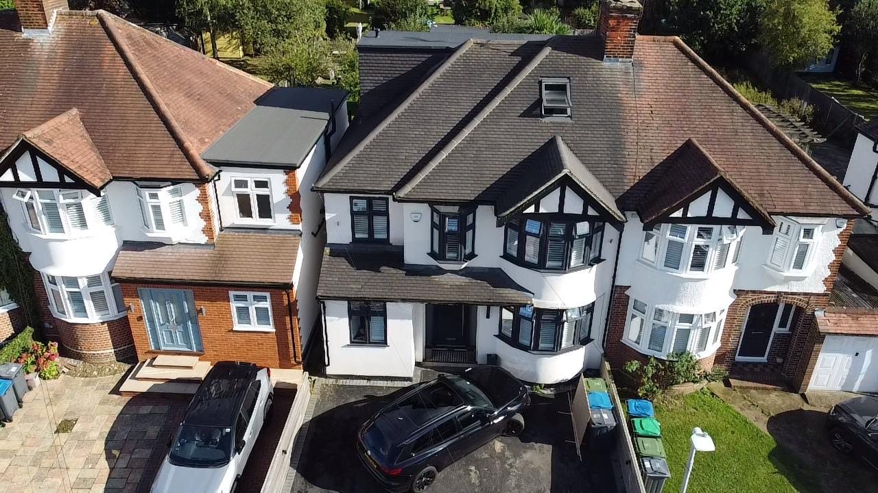 Front elevation of a house with a rear loft conversion, Tudor-gabled bays
