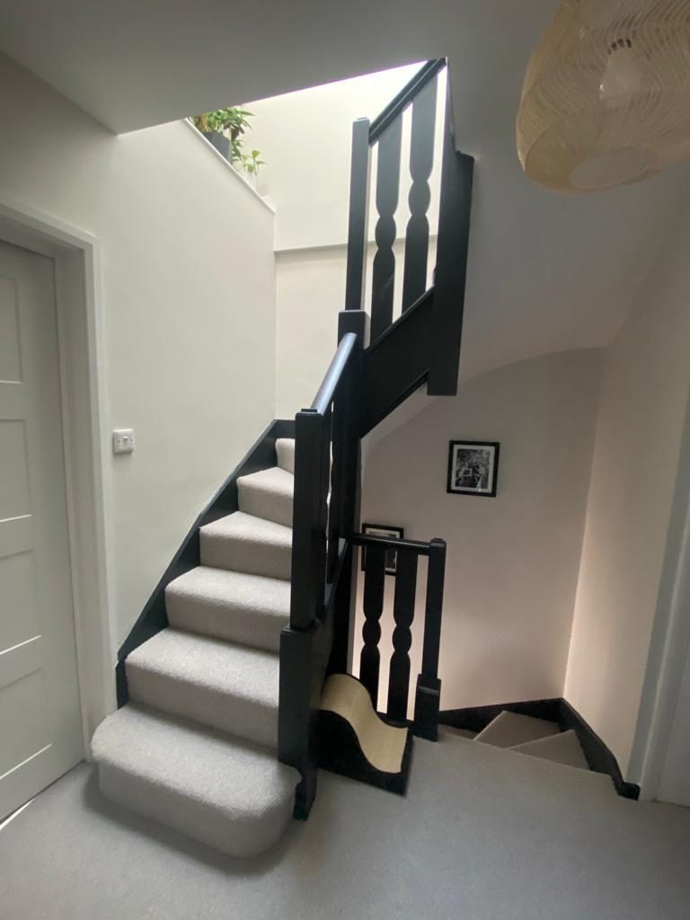 New loft staircase with black balustrade and skylight above