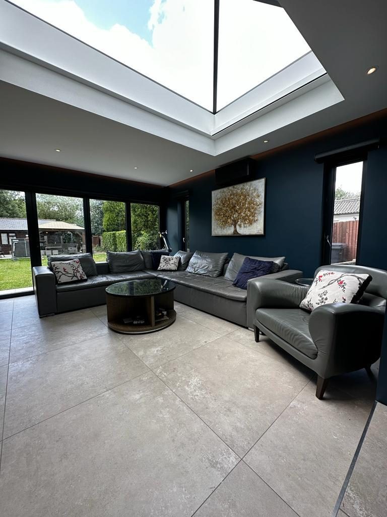 Open-plan garden room under a large roof lantern, Chessington